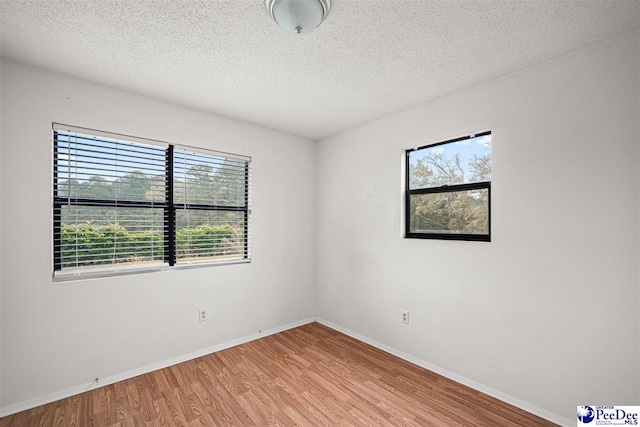 548 Mciver Rd, Florence, SC 29506 - spare room featuring baseboards, light wood-style flooring, and a textured ceiling