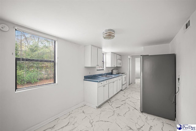 548 Mciver Rd, Florence, SC 29506 - kitchen with white cabinets, visible vents, white appliances, marble finish floor, and a sink