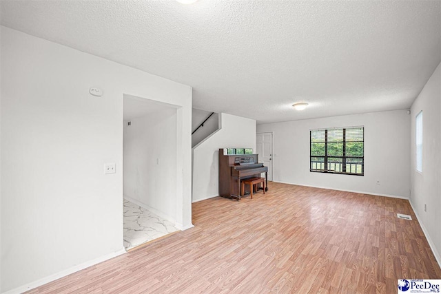 548 Mciver Rd, Florence, SC 29506 - living area featuring baseboards, visible vents, wood finished floors, and a textured ceiling