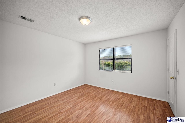 548 Mciver Rd, Florence, SC 29506 - empty room featuring baseboards, light wood-style floors, a textured ceiling, and visible vents