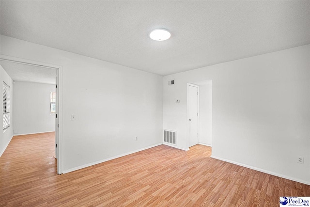 548 Mciver Rd, Florence, SC 29506 - spare room with light wood-style flooring, a textured ceiling, baseboards, and visible vents