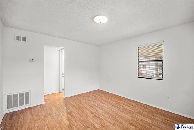 548 Mciver Rd, Florence, SC 29506 - spare room featuring baseboards, a textured ceiling, visible vents, and light wood-style floors