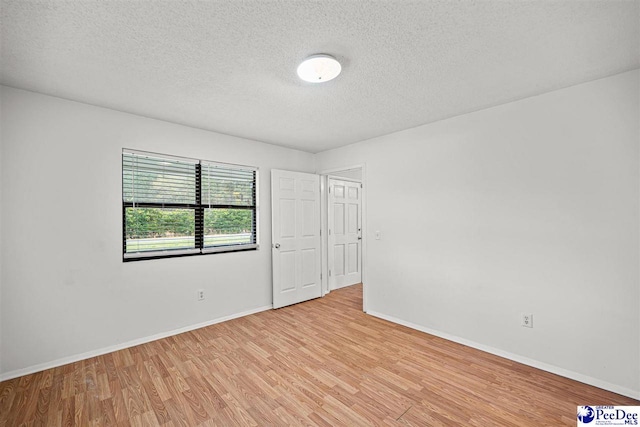 548 Mciver Rd, Florence, SC 29506 - unfurnished room featuring baseboards, light wood-style flooring, and a textured ceiling