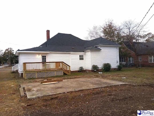 rear view of property featuring a deck and a patio area