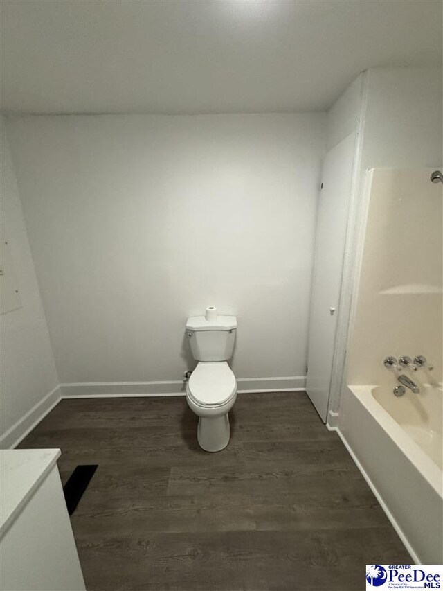 bathroom featuring wood-type flooring, vanity, and toilet