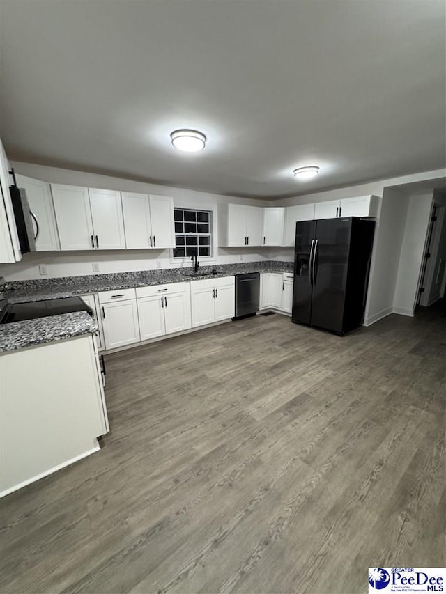 kitchen featuring white cabinetry, dark wood-type flooring, sink, and black appliances