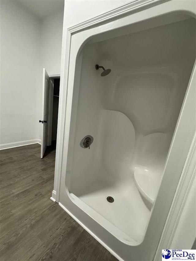 bathroom featuring hardwood / wood-style flooring and a shower