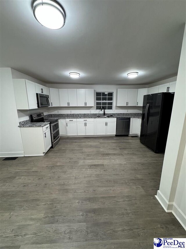 kitchen with white cabinetry, sink, dark wood-type flooring, and black appliances