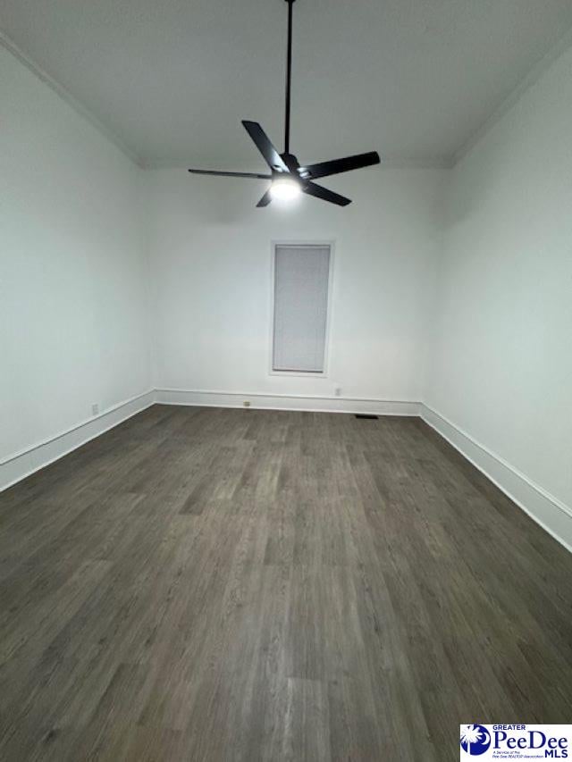 unfurnished room featuring dark wood-type flooring and ceiling fan