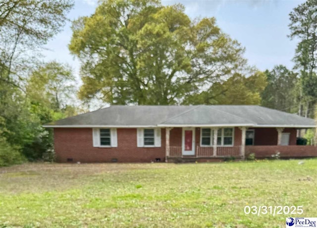ranch-style home with brick siding, a porch, a front yard, and crawl space