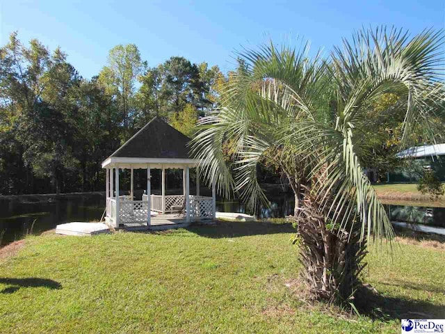 view of yard featuring a gazebo and a water view