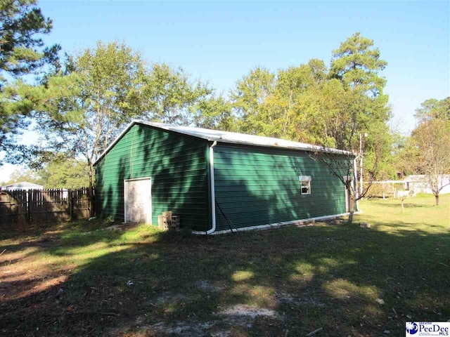 view of outbuilding featuring a yard