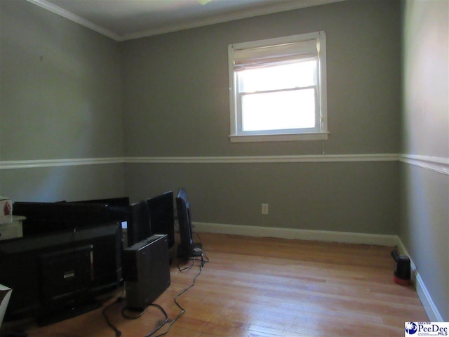 misc room featuring ornamental molding and light hardwood / wood-style floors