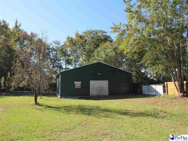 view of outbuilding with a yard