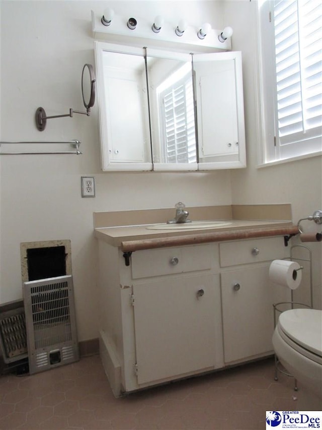 bathroom with vanity, toilet, and tile patterned flooring