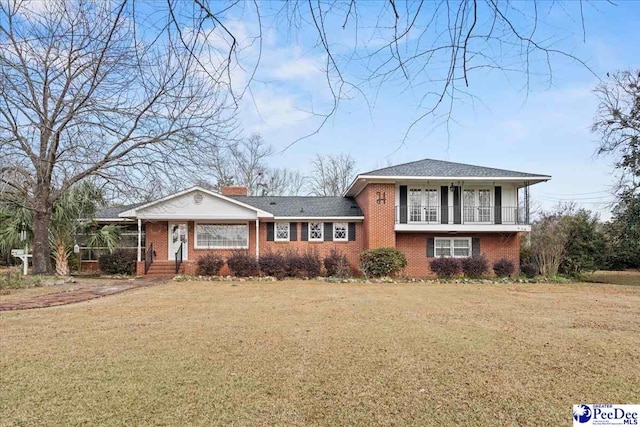 1101 E 3rd Ave, Lake View, SC 29563 - split level home with brick siding, a front yard, and a chimney