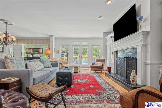130 Nez Perce Dr, Darlington, SC 29532 - living area with crown molding, a chandelier, wood finished floors, french doors, and a high end fireplace