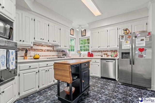 130 Nez Perce Dr, Darlington, SC 29532 - kitchen with stainless steel appliances, white cabinetry, light countertops, crown molding, and backsplash