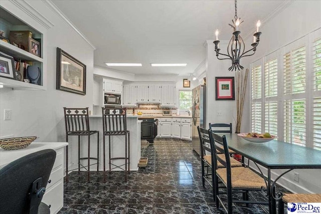 130 Nez Perce Dr, Darlington, SC 29532 - kitchen featuring black microwave, white cabinets, a chandelier, a peninsula, and crown molding