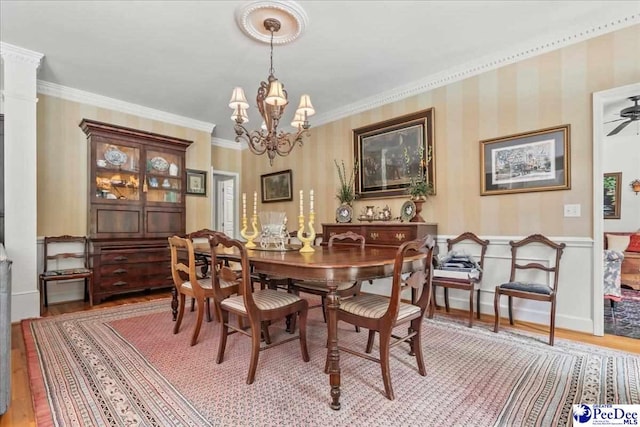 130 Nez Perce Dr, Darlington, SC 29532 - dining area featuring light wood-type flooring, wallpapered walls, a chandelier, crown molding, and wainscoting