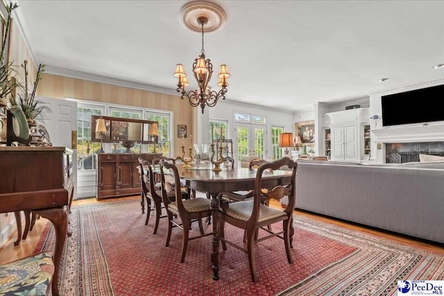 130 Nez Perce Dr, Darlington, SC 29532 - dining area with wood finished floors, crown molding, a chandelier, and french doors