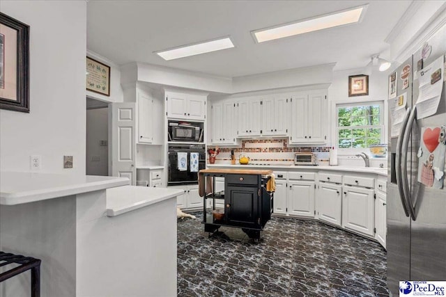 130 Nez Perce Dr, Darlington, SC 29532 - kitchen featuring black appliances, white cabinets, light countertops, and crown molding