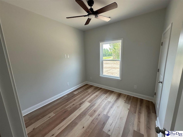 7845 E National Cemetery Rd, Florence, SC 29506 - unfurnished room with wood finished floors, baseboards, and a ceiling fan