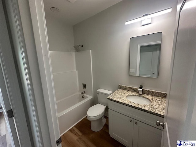 7845 E National Cemetery Rd, Florence, SC 29506 - full bath with wood finished floors, toilet, vanity, and bathing tub / shower combination