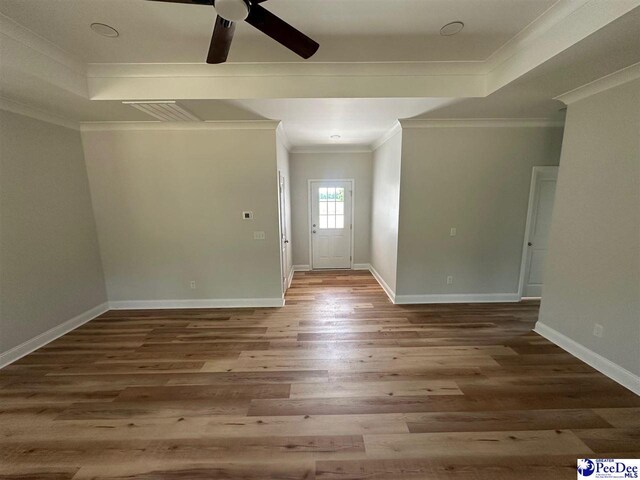 7845 E National Cemetery Rd, Florence, SC 29506 - foyer featuring ceiling fan, wood finished floors, crown molding, baseboards, and a tray ceiling