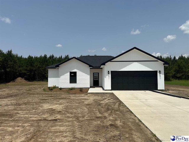 7845 E National Cemetery Rd, Florence, SC 29506 - view of front facade with an attached garage and driveway