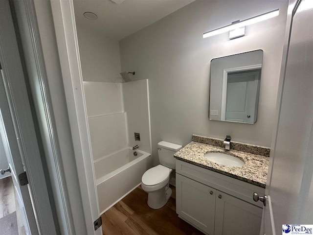 7845 E National Cemetery Rd, Florence, SC 29506 - bathroom with wood finished floors, toilet, vanity, and washtub / shower combination