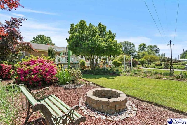 view of yard with a fire pit and a deck