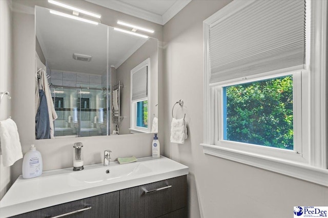 full bath with crown molding, vanity, and a shower stall