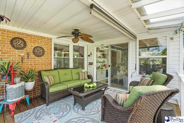 sunroom featuring outdoor lounge area and ceiling fan