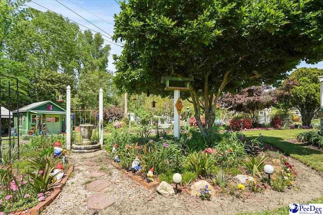view of yard with an outdoor structure and fence