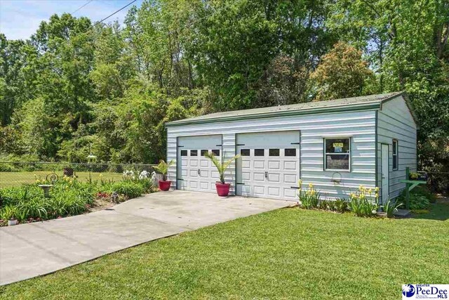 detached garage featuring fence