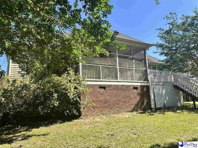 2143 Glenmore Way, Florence, SC 29505 - back of property with a lawn, stairway, a sunroom, and brick siding
