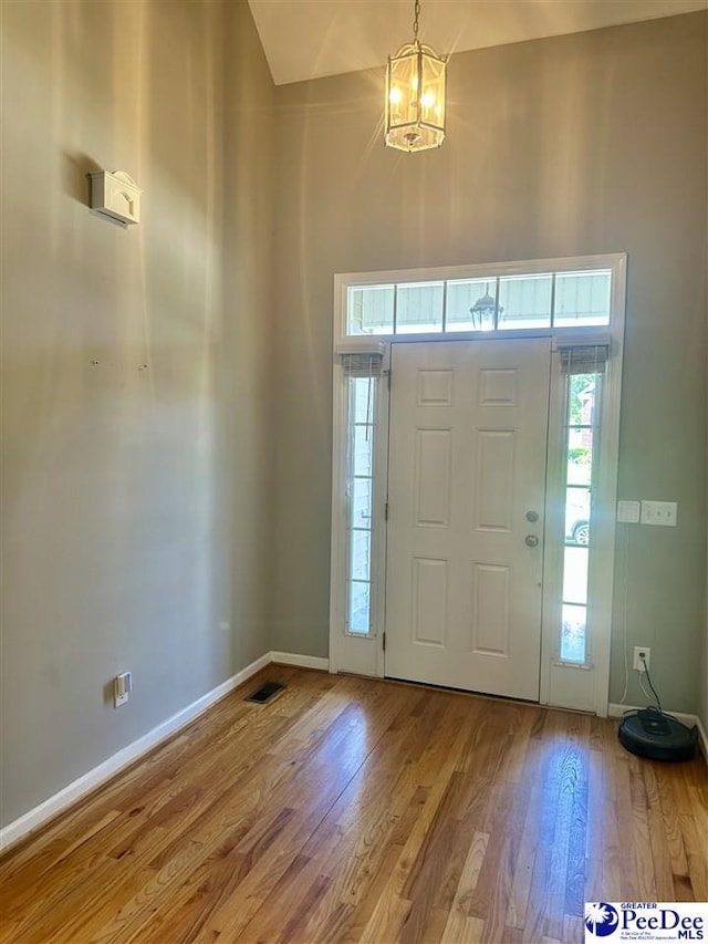 2143 Glenmore Way, Florence, SC 29505 - foyer entrance with a chandelier, healthy amount of natural light, wood finished floors, and a high ceiling