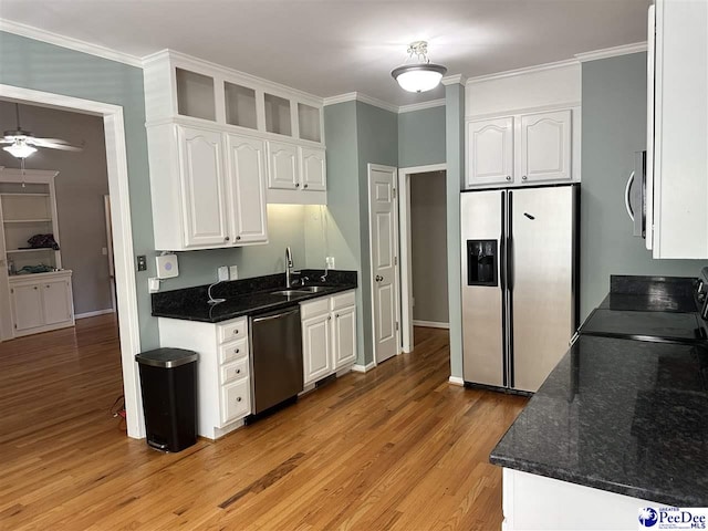 2143 Glenmore Way, Florence, SC 29505 - kitchen with stainless steel appliances, light wood-style flooring, white cabinetry, ornamental molding, and ceiling fan