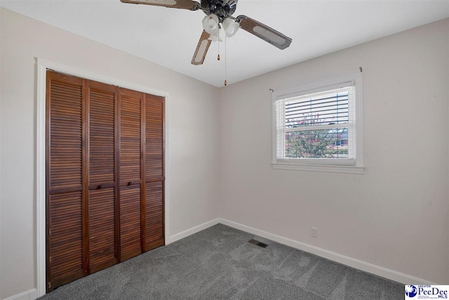 unfurnished bedroom featuring a closet, ceiling fan, and carpet floors