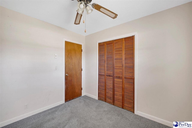 unfurnished bedroom featuring a closet, ceiling fan, and carpet flooring