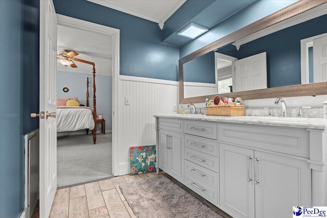 1311 Pinckney Ave, Florence, SC 29505 - full bathroom featuring a wainscoted wall, double vanity, wood finished floors, crown molding, and ensuite bath
