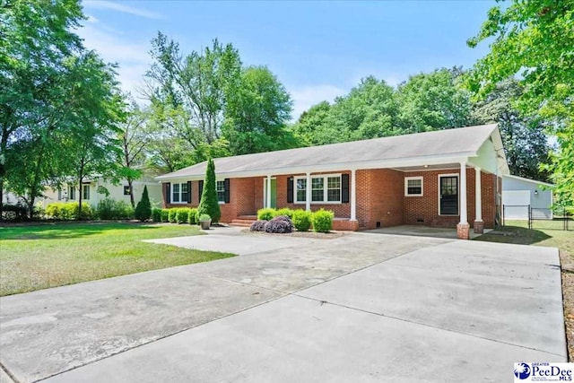 ranch-style house with brick siding, an attached carport, crawl space, a front yard, and concrete driveway