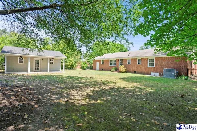 view of yard featuring central air condition unit and a patio area