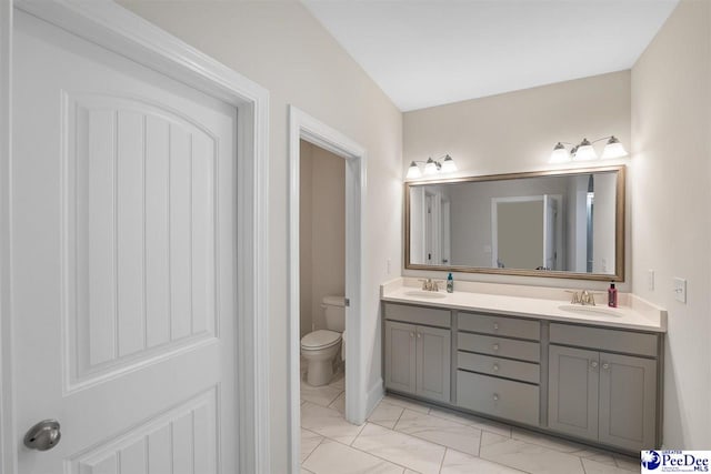 bathroom featuring vanity and toilet