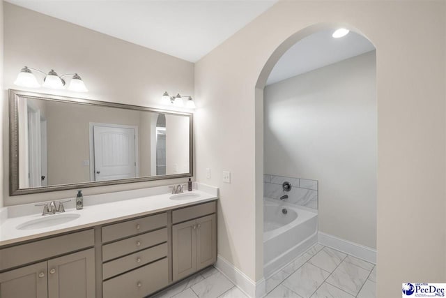 bathroom with vanity and a tub to relax in