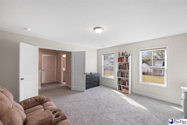 living area featuring light carpet