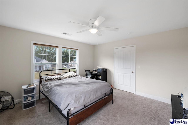 carpeted bedroom featuring visible vents, ceiling fan, and baseboards