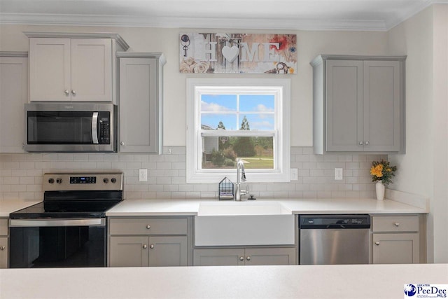 kitchen featuring ornamental molding, stainless steel appliances, sink, and backsplash