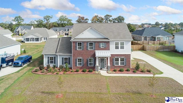 view of front of property featuring driveway, brick siding, fence, and a residential view